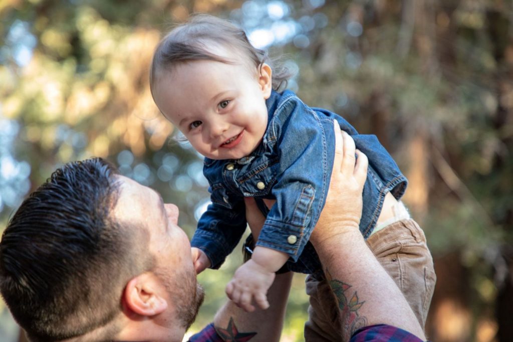 Man holding child in air